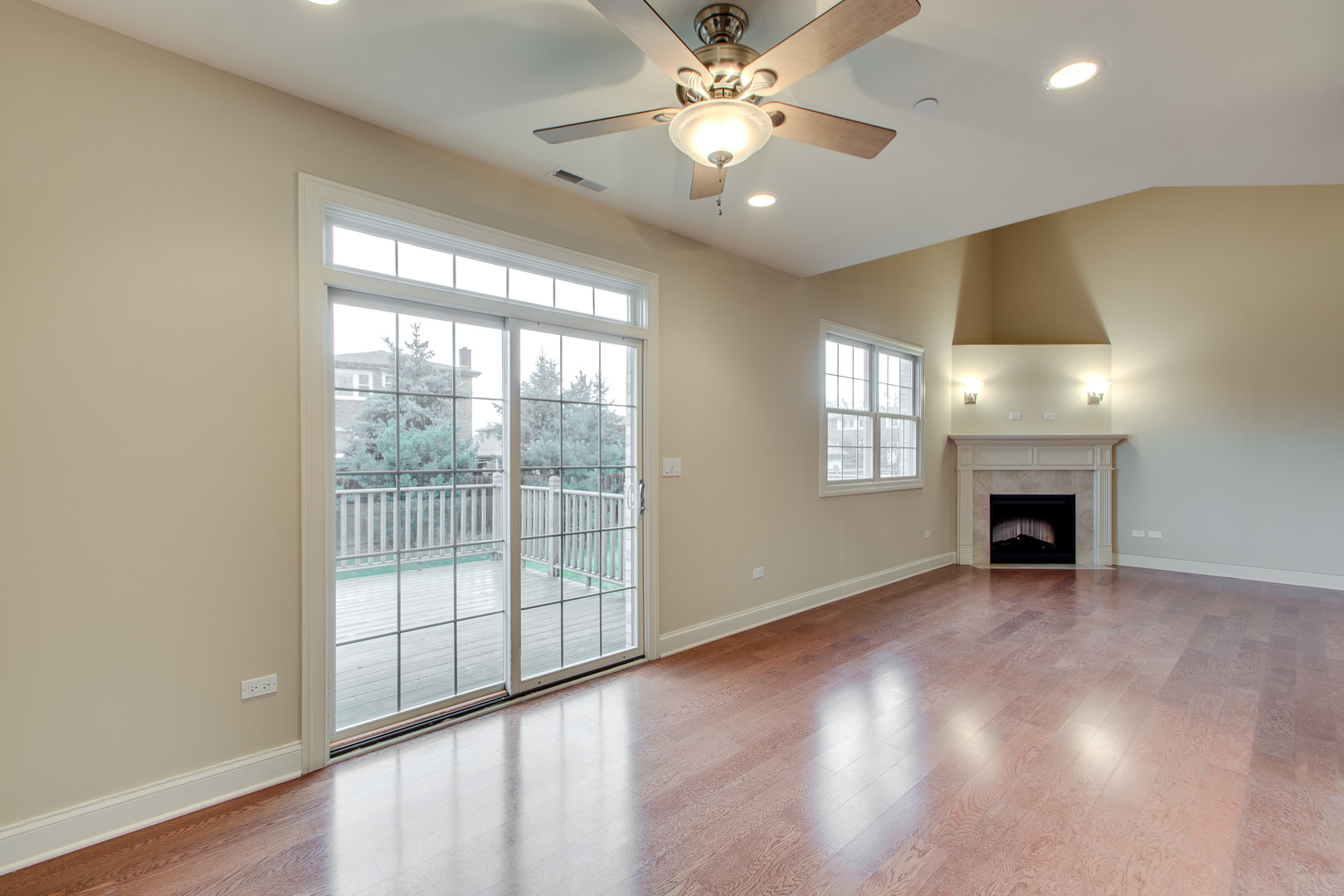 8705 Covington Place Justice, IL 60458 - Photo 5 of 30 an empty room with windows fireplace and chandelier