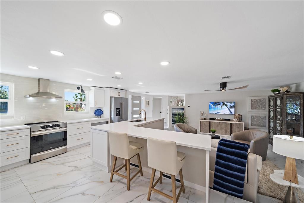 3149 Homasassa Road Sarasota, FL 34239 - Photo 11 of 62 a kitchen with stainless steel appliances kitchen island granite countertop a sink and cabinets