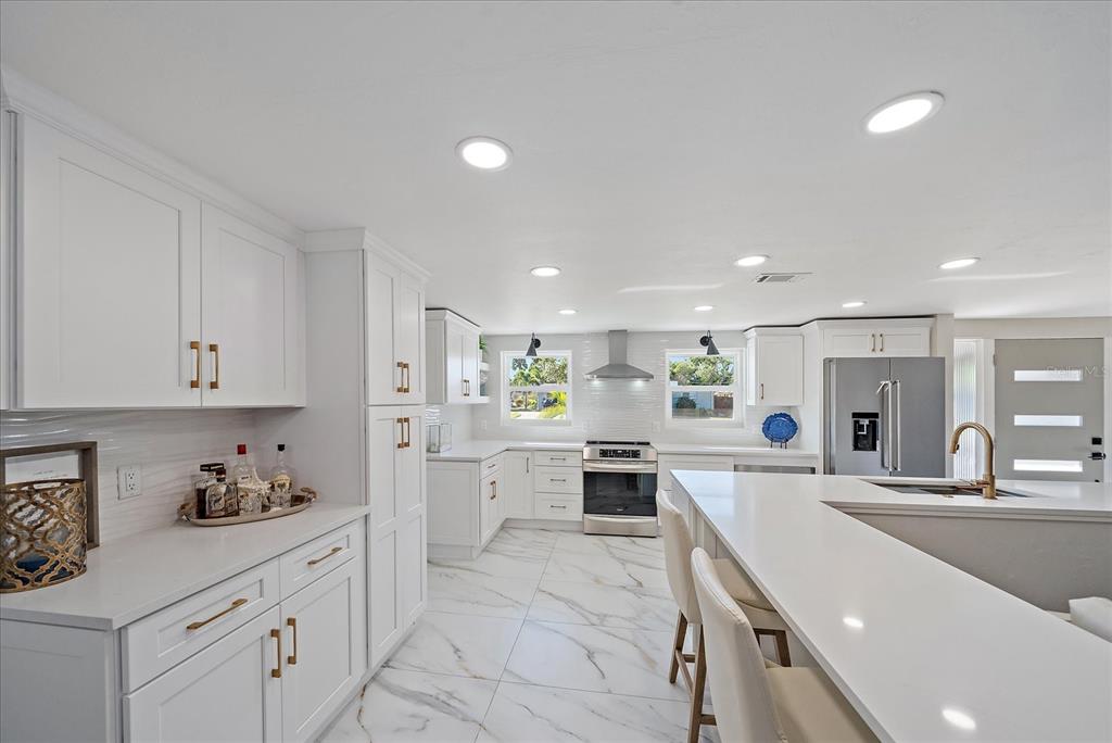 3149 Homasassa Road Sarasota, FL 34239 - Photo 12 of 62 a large white kitchen with lots of counter space a sink and appliances