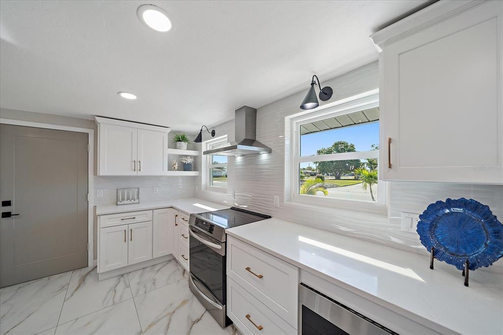 3149 Homasassa Road Sarasota, FL 34239 - Photo 14 of 62 a kitchen with stainless steel appliances a sink and a stove
