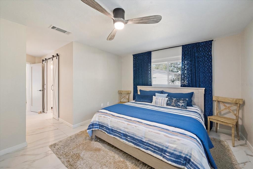 3149 Homasassa Road Sarasota, FL 34239 - Photo 26 of 62 a bedroom with a bed and a chandelier