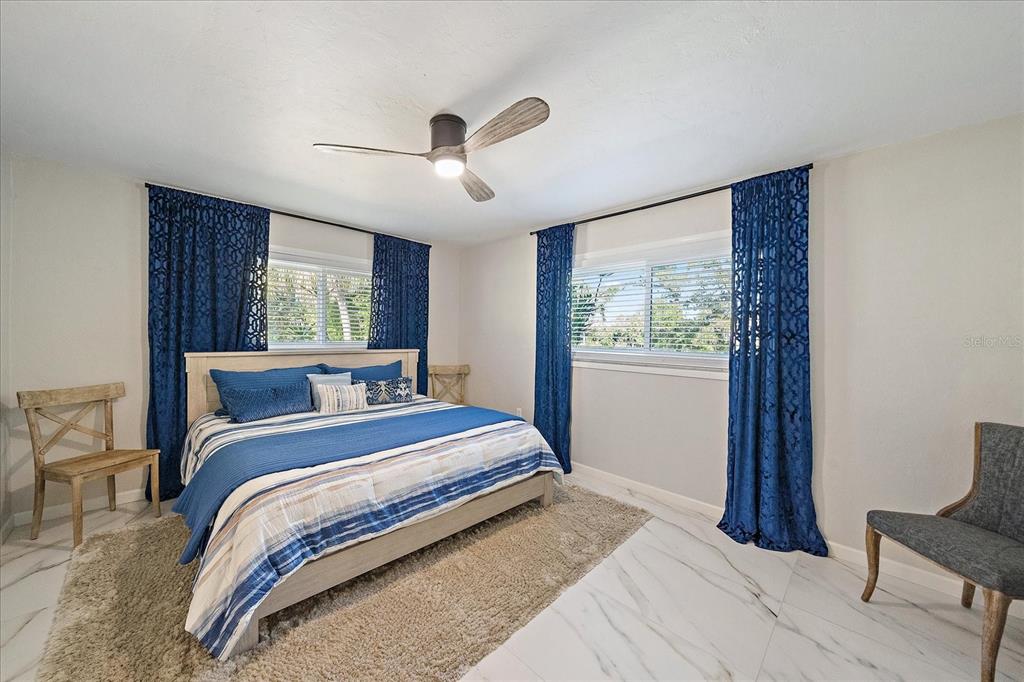 3149 Homasassa Road Sarasota, FL 34239 - Photo 27 of 62 a bedroom with a large bed and a large window