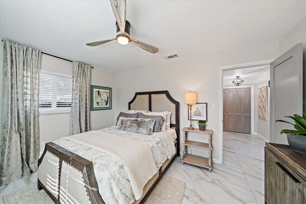 3149 Homasassa Road Sarasota, FL 34239 - Photo 33 of 62 a bedroom with a large bed and a chandelier