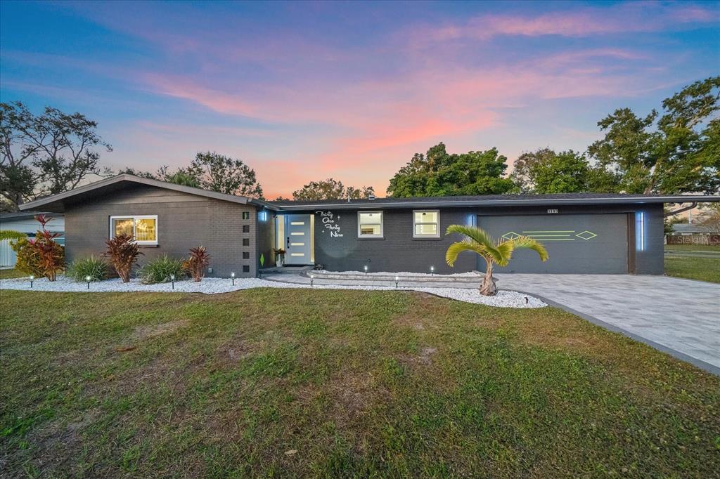 3149 Homasassa Road Sarasota, FL 34239 - Photo 61 of 62 a front view of a house with a garden and yard