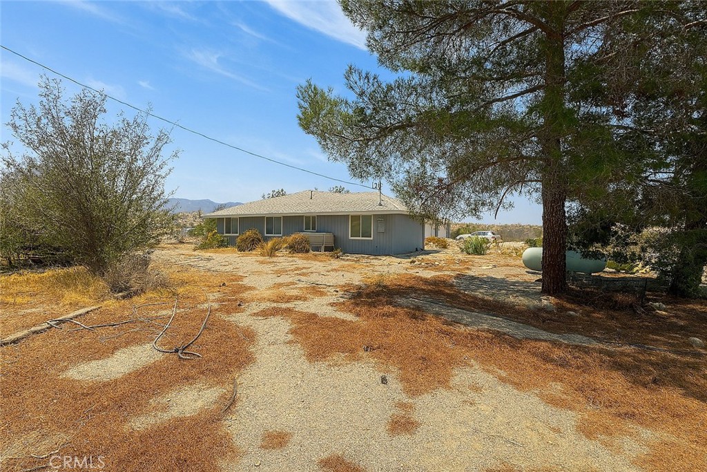 13384 Sheep Creek Road Phelan, CA 92371 - Photo 5 of 13 a front view of a house with a yard