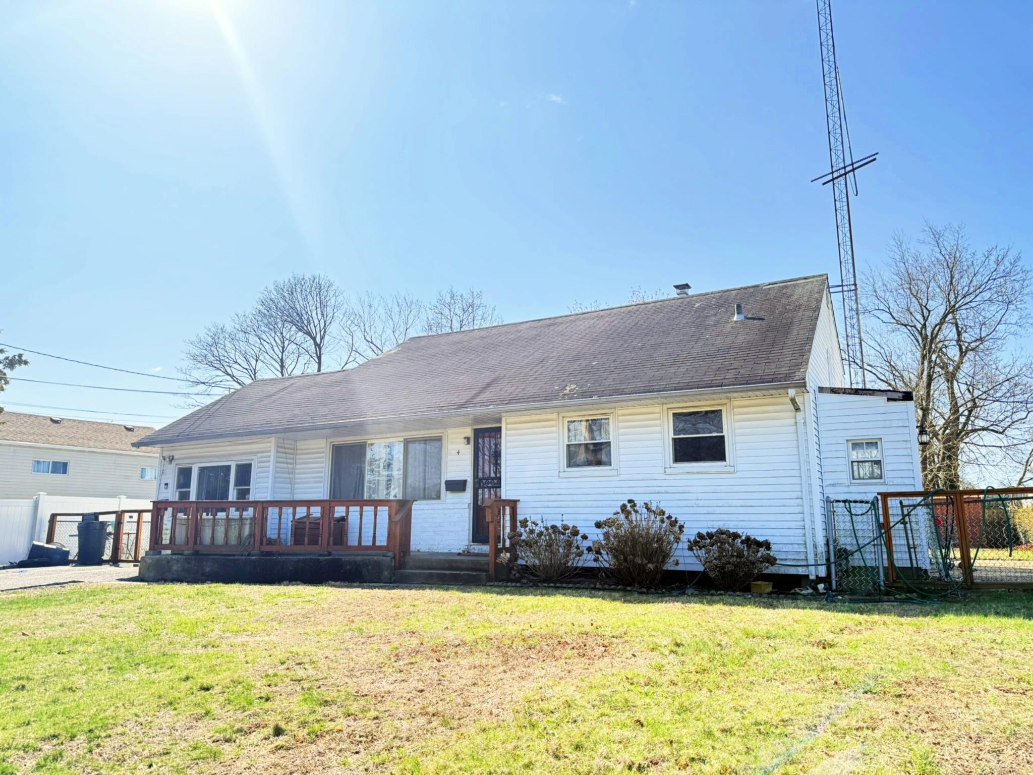 4 McClellan Avenue Bay Shore, NY 11706 - Photo 1 of 1 View of front of home with roof with shingles, fence, and a front lawn