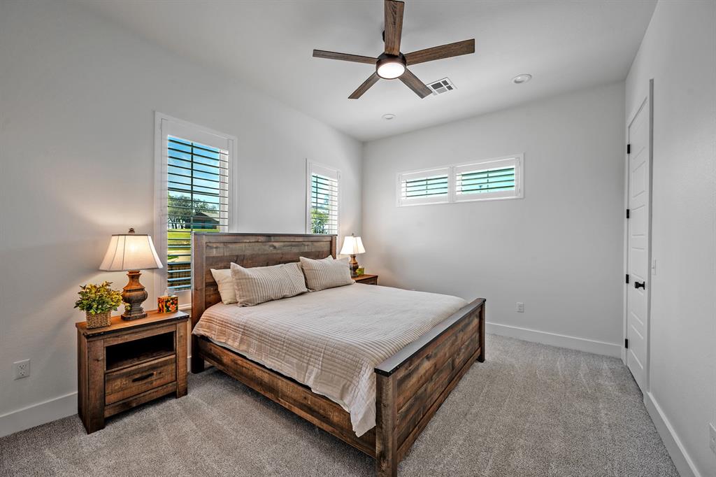 4509 Peach Tree Lane Kingston, OK 73439 - Photo 28 of 39 a bedroom with a bed and a chandelier