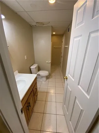 a bathroom with a toilet mirror and sink