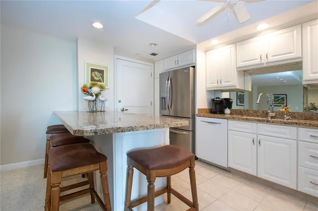 a kitchen with stainless steel appliances granite countertop a sink and cabinets