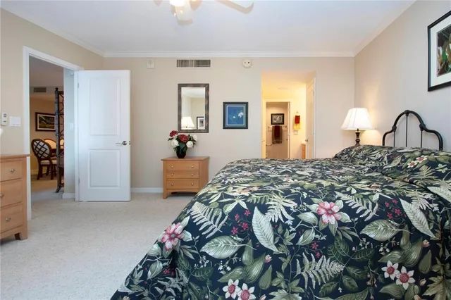 a bedroom with two beds and a chandelier