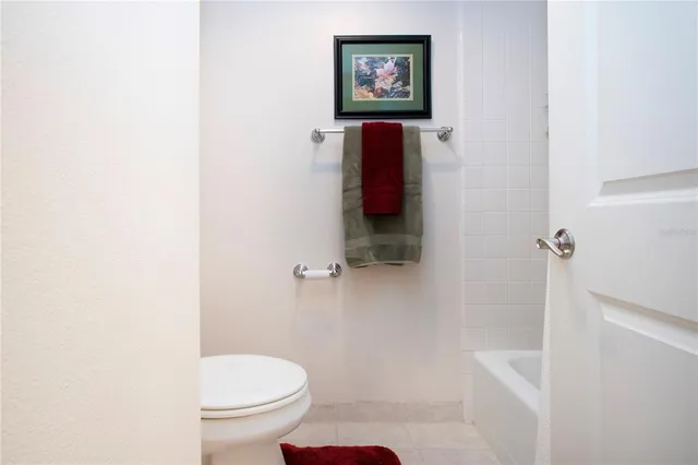 a spacious bedroom with a bed and a chandelier