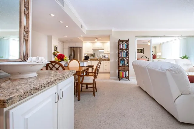 a view of a dining room with furniture and a book shelf