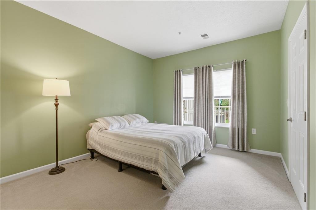 411 Stockton Ridge Cranberry Township, PA 16066 - Photo 14 of 32 a bedroom with a bed and a lamp