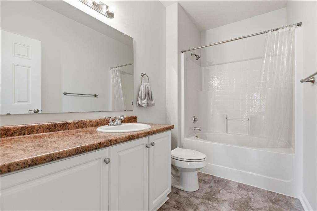 411 Stockton Ridge Cranberry Township, PA 16066 - Photo 16 of 32 a bathroom with a granite countertop sink a toilet and shower