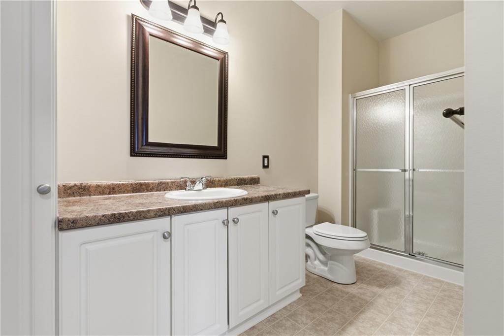 411 Stockton Ridge Cranberry Township, PA 16066 - Photo 20 of 32 a bathroom with a granite countertop sink toilet a mirror and shower