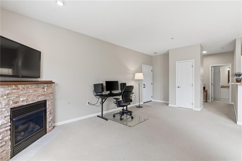 411 Stockton Ridge Cranberry Township, PA 16066 - Photo 3 of 32 a view of a livingroom with a flat screen tv and a fireplace