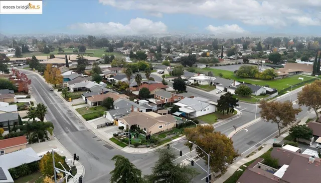 a view of a big house with swimming pool and sitting area
