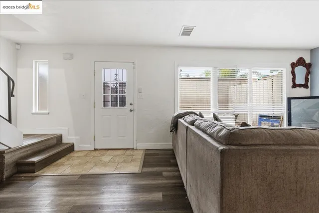 a living room with a couch and a window