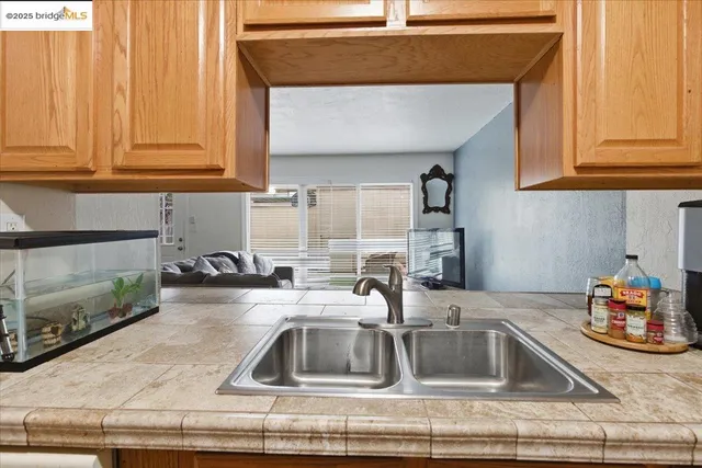 a kitchen with granite countertop a sink and a stove top oven