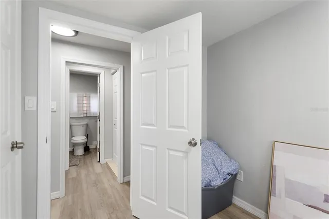 a view of a hallway with closet and wooden floor