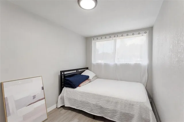 a bedroom with a bed and window