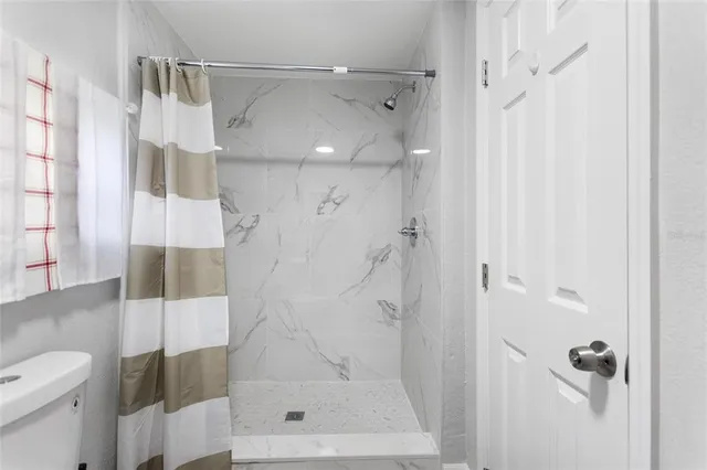 a bathroom with a shower and a toilet