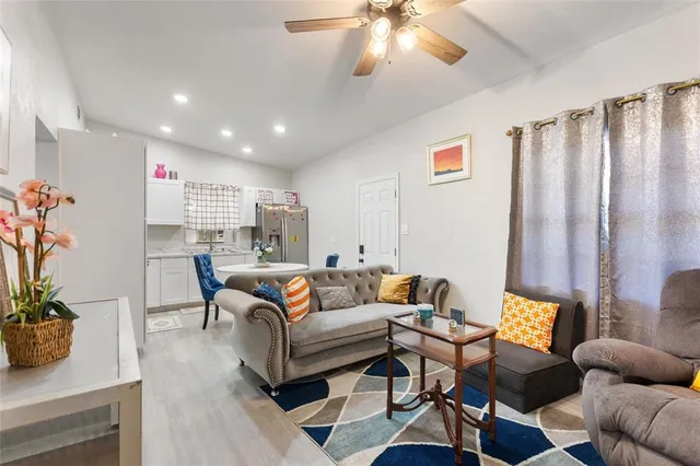 a living room with furniture and a potted plant
