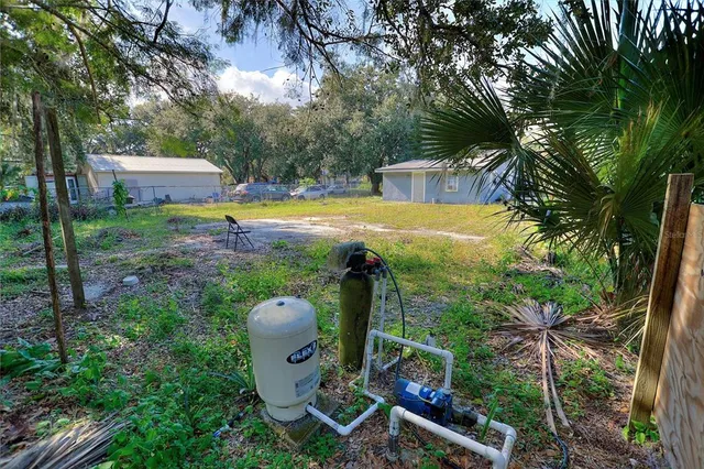 a view of a house with backyard and sitting area