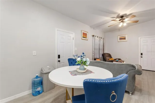 a dining room with furniture and wooden floor