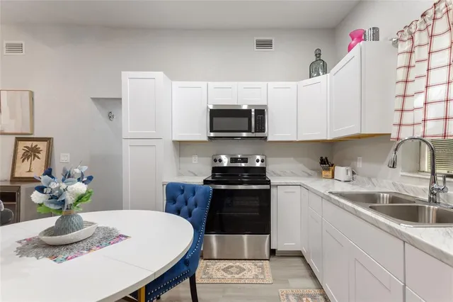 a kitchen with a stove a sink and a refrigerator