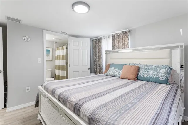 a bedroom with a large bed and a window