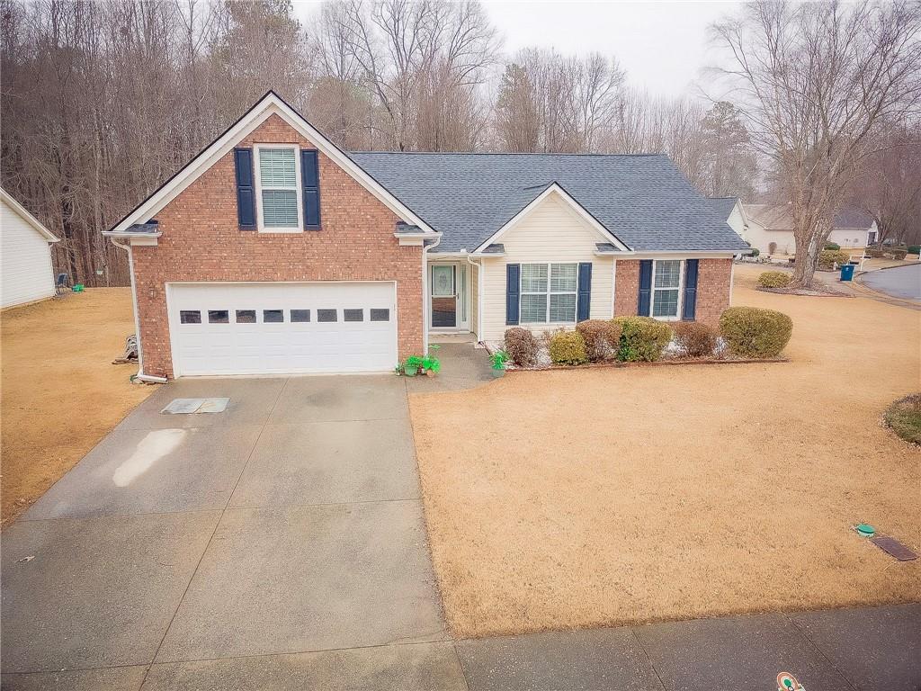265 Circle Road Dacula, GA 30019 - Photo 1 of 1 a front view of a house with a yard and garage
