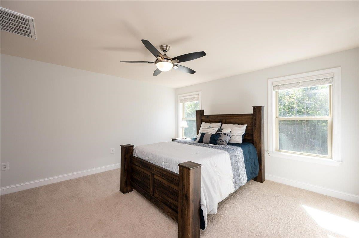 7108 Rex Road Holly Springs, NC 27540 - Photo 26 of 38 Nice big bedroom towards the back of the house and with views of the backyard. This room has 2 closets and it's own bathroom! Bedroom 4 is a suite!