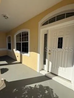 a view of a house with wooden floor and entryway