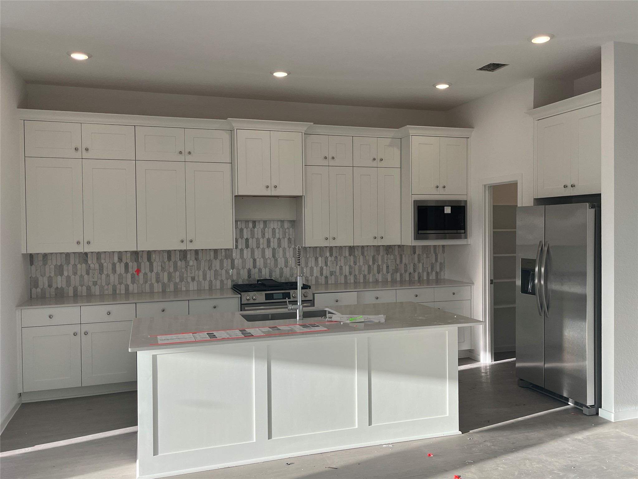 28959 Rustic Robin Lane Hockley, TX 77447 - Photo 12 of 13 a kitchen with kitchen island granite countertop white cabinets and refrigerator