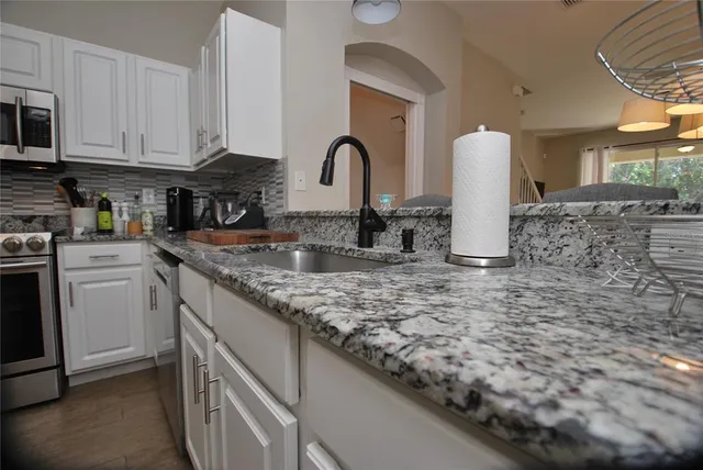 a view of a dining room with furniture wooden floor and chandelier