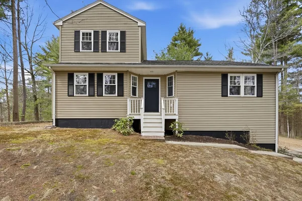 a front view of a house with a yard