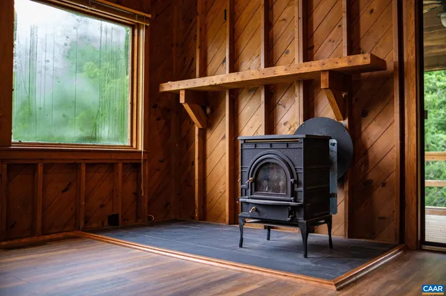 a living room with wooden floor and a window
