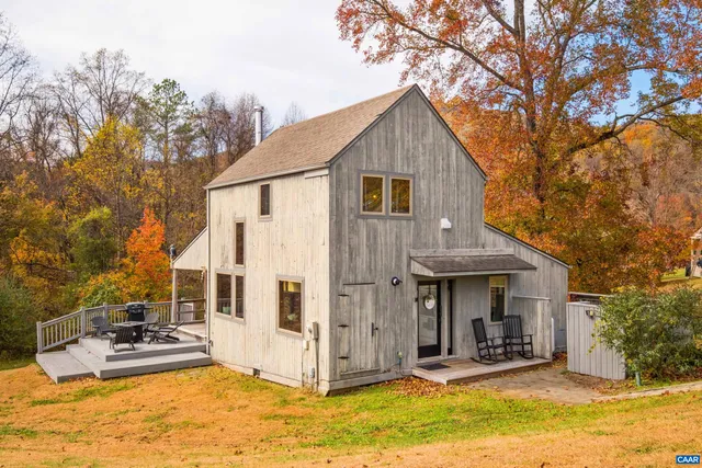 a view of a house with yard and sitting area