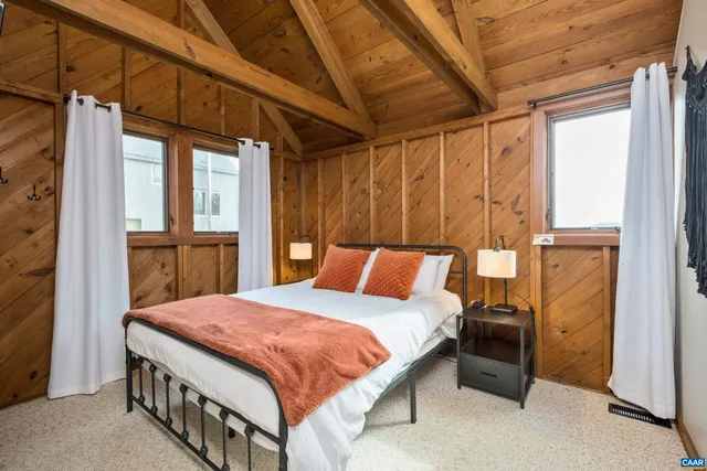 a bed sitting in a bedroom next to a window