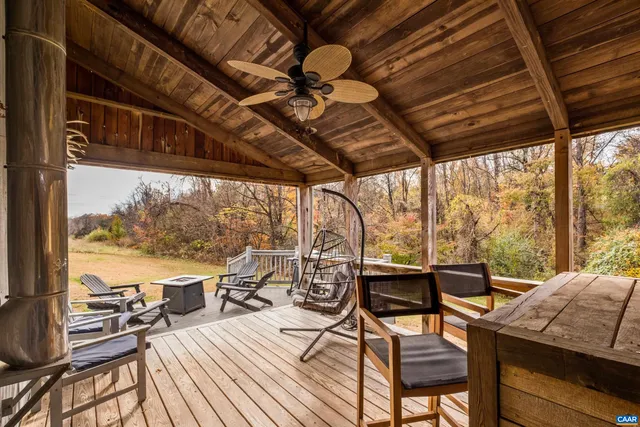 a view of a patio with lawn chairs next to a yard