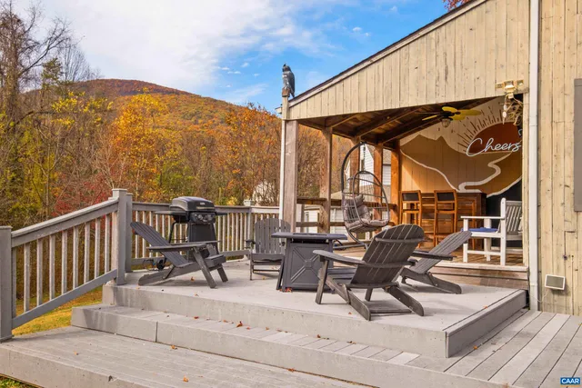 a view of a roof deck with furniture