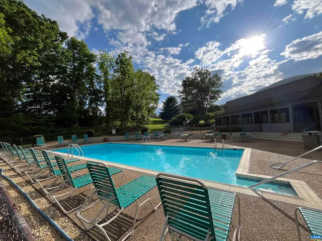 a view of a patio with swimming pool table and chairs