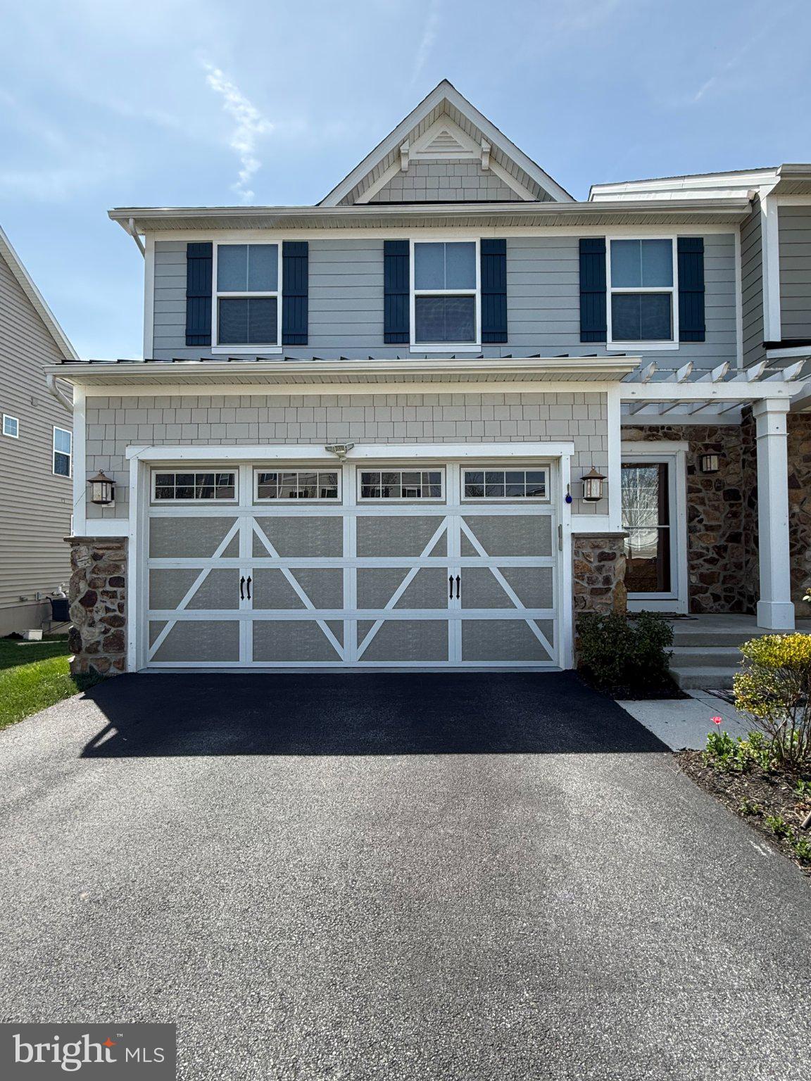 322 Patriots Path Malvern, PA 19355 - Photo 1 of 12 a front view of a house with a garden and garage