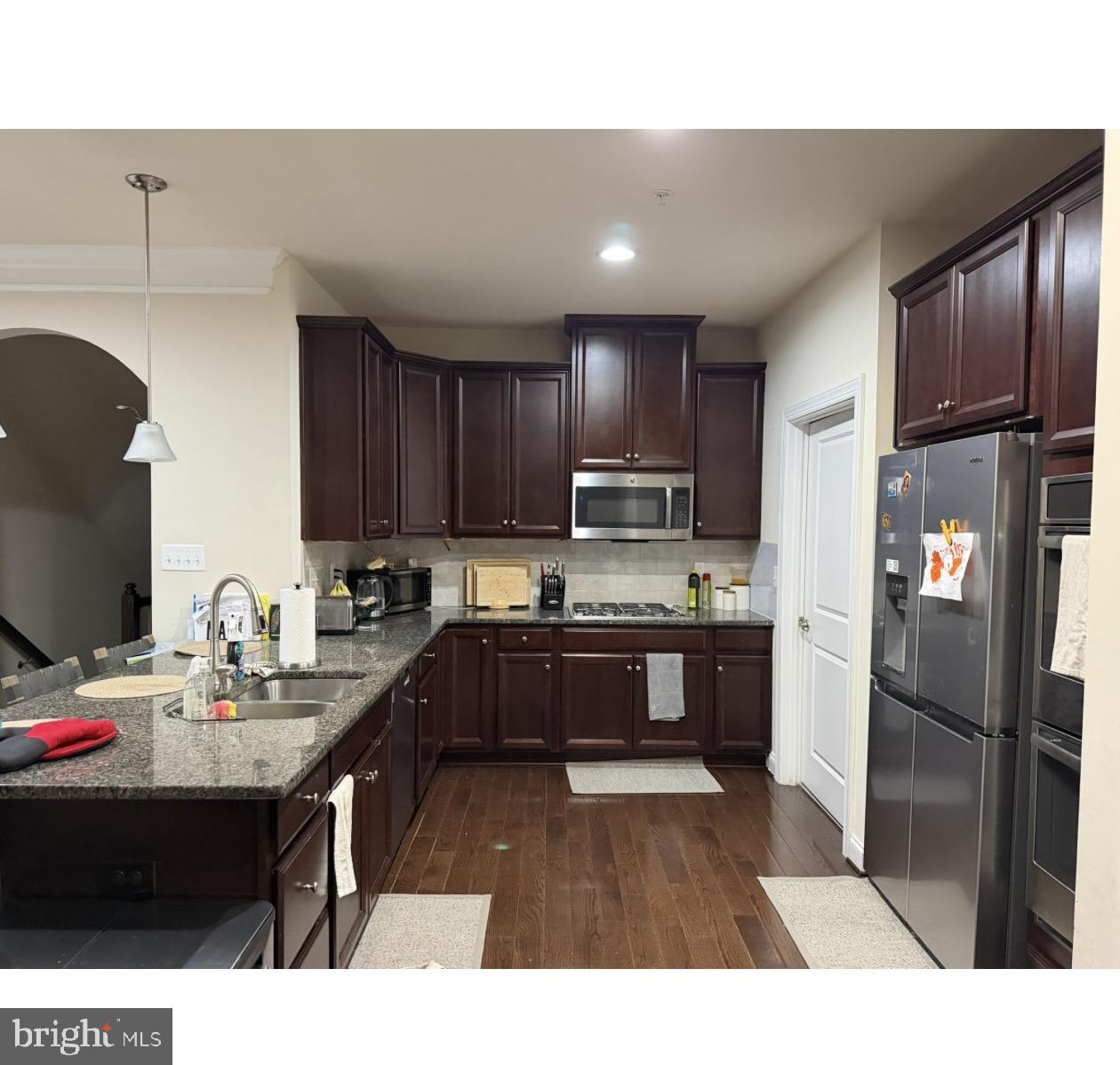 322 Patriots Path Malvern, PA 19355 - Photo 6 of 12 a kitchen with stainless steel appliances kitchen island granite countertop a refrigerator stove top oven and sink