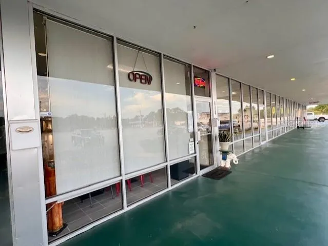 a room with lots of windows and palm table