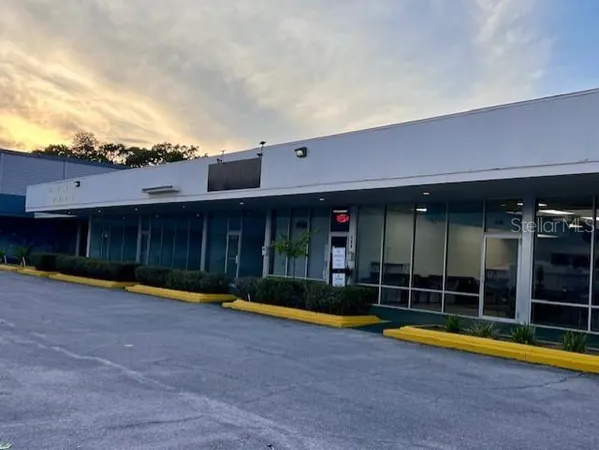 a view of a house with a swimming pool and a yard