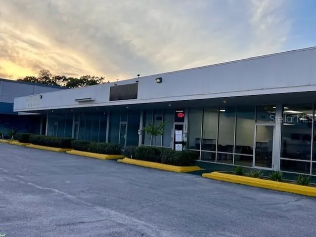 a view of a house with a swimming pool and a yard