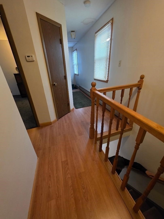 478 Tucker Street Fall River, MA 02721 - Photo 15 of 38 a view of a hallway with wooden floor and staircase