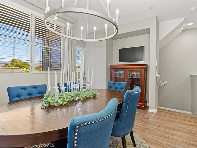 a dining room with furniture and wooden floor